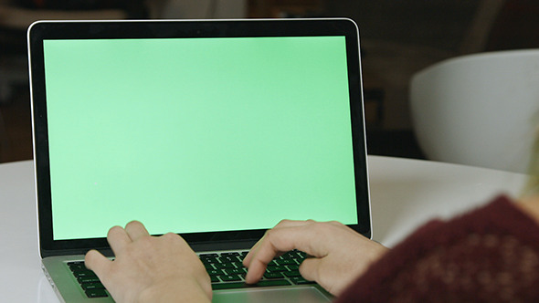 Girl Typing on Laptop with Green Screen