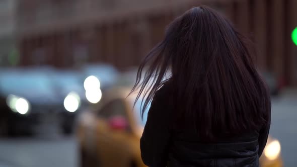 Portrait of a Brunette with Long Hair in a Knitted Sweater and a Dark Coat on a Cloudy Day alt