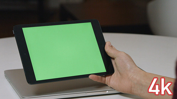 Holding Tablet with Green Screen