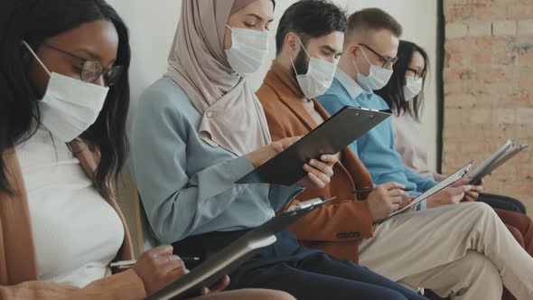 People in Face Masks Waiting for Job Interview alt