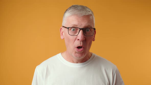 Handsome Senior Man Wearing Glasses Afraid and Shocked with Surprise Expression