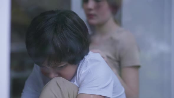 Abused Frightened Little Boy Crying As Teenage Girl Calming Down Sibling Indoors alt