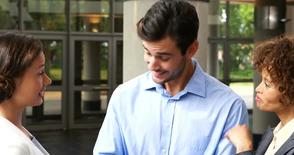 Business executives discussing over digital tablet alt