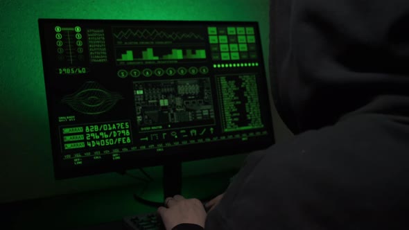 Computer Hacker Typing Code on Keyboard Late Night Working and Bypassing Cyber Security alt