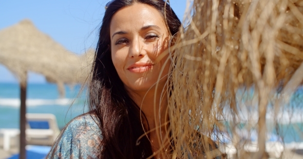 Pretty Lady Leaning Her Head On Beach Umbrella alt