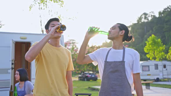 Group of Asian man and woman are having new year party outdoor in the evening together. alt