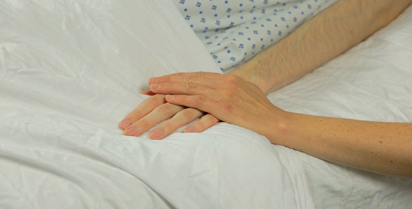 Woman Gives Male Patient a Friendly Pat on Hand