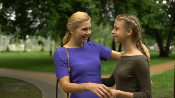 Mother Walking Her Grown-Up Daughter to University, Beginning of Students Life alt