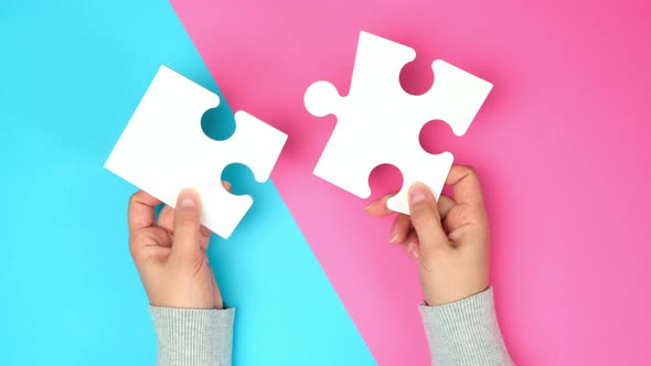 empty paper white pieces of puzzles in female hands, puzzle connected alt
