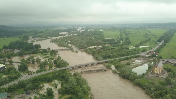 Aerial View of the Bridge During Floods. Extremely High Water Level in the River.