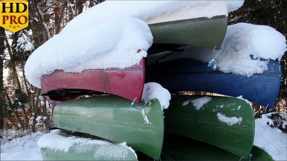 Seven Boats Piled Upside Down with Snow