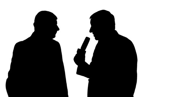 Silhouettes of Reporter Interviewing a Man 