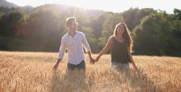 Couple In Love Running Across The Wheat Field