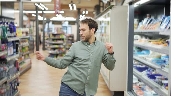 Man in Supermarket Positive Dances in an Empty Food Store alt
