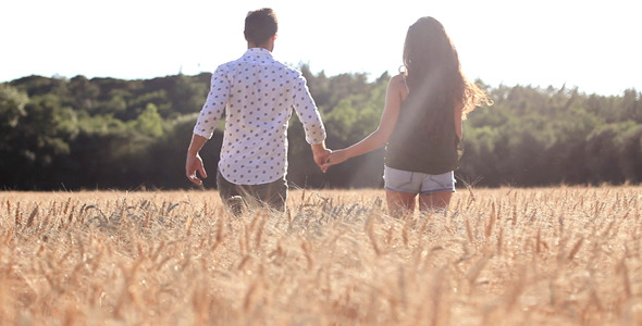 Couple Running Across The Wheat Field