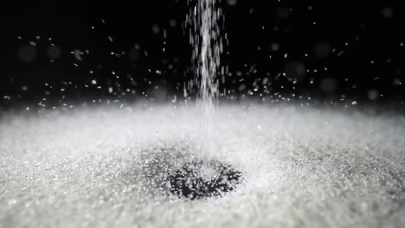 Particles of White Dry Sand Pour in Stream Hit the Surface and Scatter in Different Directions on an alt
