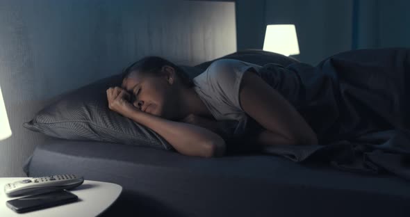 Woman suffering from insomnia in her bed