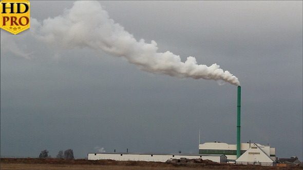 A Factory with White Smoke Release