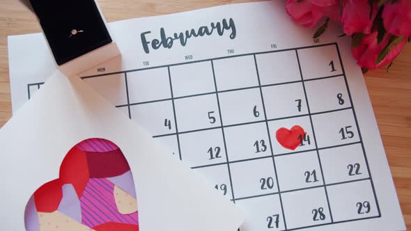 Valentine's Day Attributes on Table - Calendar with Heart Shape, Flowers and Ring alt