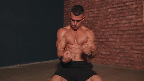 Young Man Without a Tshirt Hits His Muscular Chest with His Fists During Training and Shows Off His alt