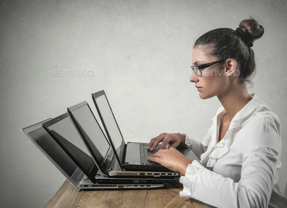 Busy employee working on several pcs at the same time