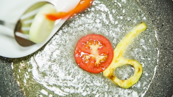 Letters Of Vegetables Being Fried In Pan