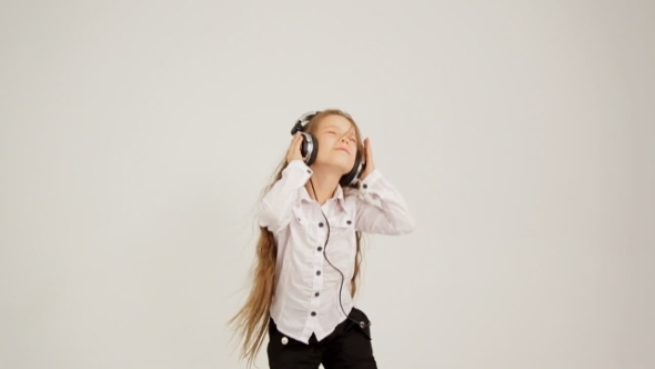 Little Girl Listening To Music With Headphones