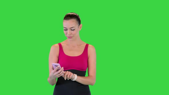 Sporty Woman with Smartphone Walking on a Green Screen Chroma Key