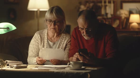 Senior Couple Calculating Utility Payments Together alt