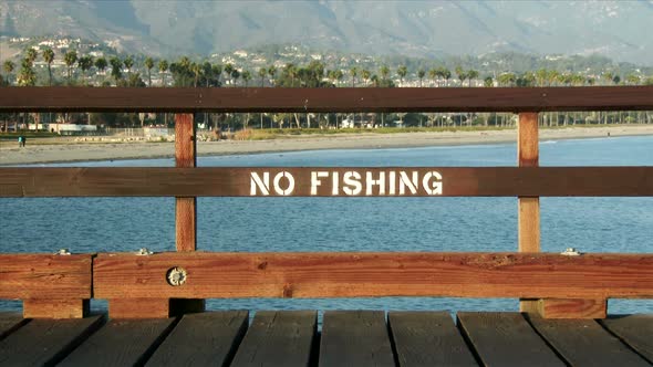 No Fishing Sign Painted On Pier alt