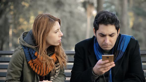 woman arguing with her boyfriend using cell phone and does not listen to her alt