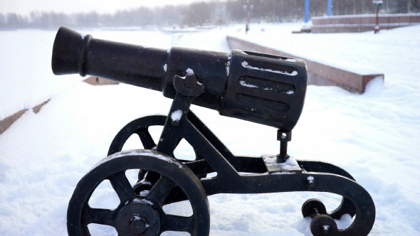 Ancient Cannon at City Quay in a Snowy Winter Day