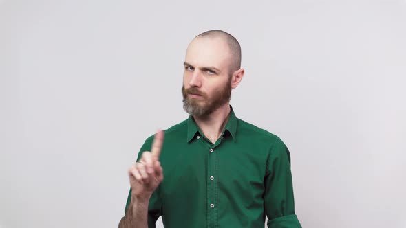 Man showing refusal gesture no, shaking his head and finger isolated over white background.