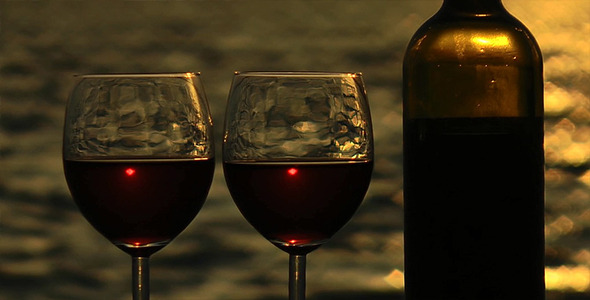 Glasses of Wine and Wine Bottle at Sunset