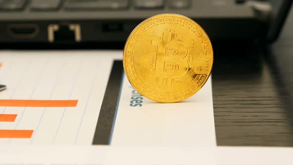 Finance Reports And Golden Bitcoin  On Office Desk Motion View