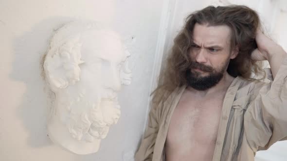 Creative Crisis of Male Charismatic Artist Man is Learning on White Wall in Workshop alt