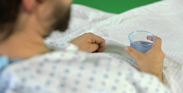 Hospital Patient Drinking a Cup of Water