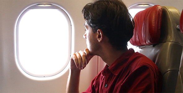Man Looking Through the Airplane Window alt
