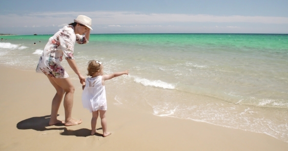 Mom With Her Little Girl Enjoying The Ocean View alt