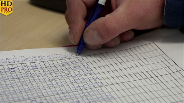 A Man Writing Numbers on the Paper