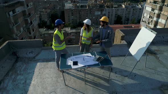 Team of Architects People in Group on Construction Site Check Documents
