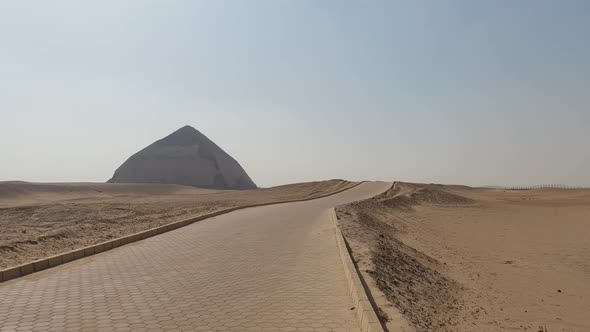 Sandy Yellow Desert With Ancient Egyptian Bent Pyramid On The Horizon, Egypt alt