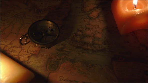 Two Candles Lit Near the Map and the Compass