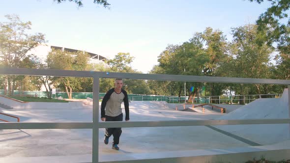Young Man Doing Parkour Tricks in Extreme Sports Park alt