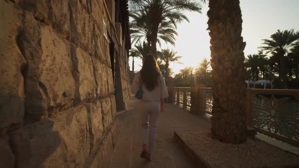 Woman Walking on the Riverfront in Luxury Neighborhood in Dubai