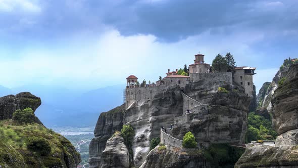 Great timelapse view of Varlaam monastery at Meteora valley in Greece and tourists rush up and down