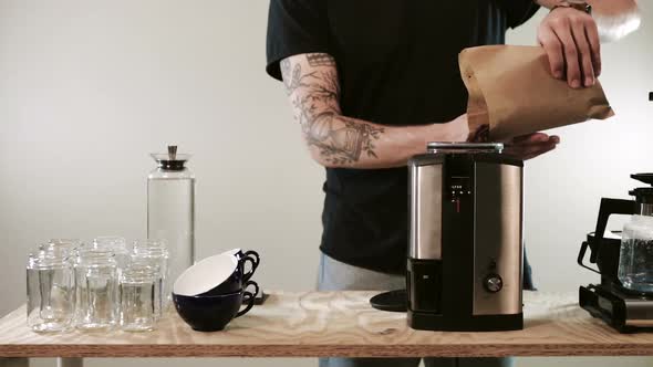 Barista Prepares and Grinds Coffee Beans