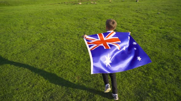Boy waving the Australian flag. alt