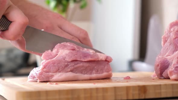 Man Cuts Meat with Knife on Wooden Board Preparation Minced Beef Pork for Cutlets Meatballs Chops