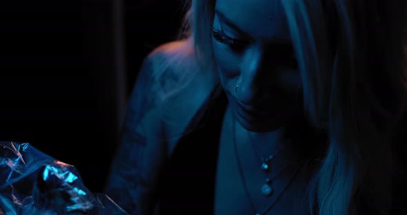 Close up of a young female tattoo artist during her work in studio. BMPCC 4K alt